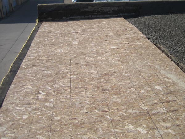 flat-roof-repair-Glendale-CA-California-2 | Shark Roofing Systems OSB plywood subfloor on a ramp with taped seams and a yellow edge along the left side.